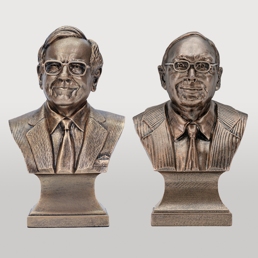 Bronze bust statue of Warren Buffett and Charlie Munger displayed side by side with realistic, lifelike detail.
